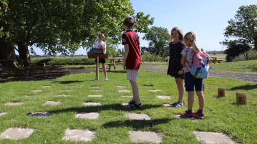 Kinderen bij het coördinatenspel in de speurtuin