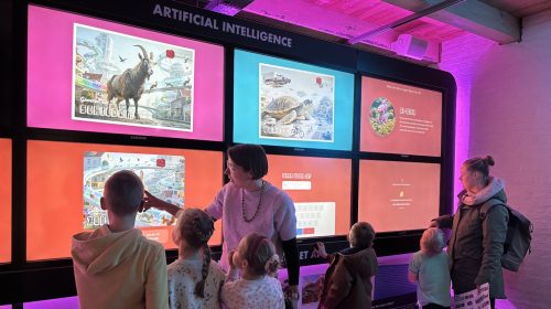 Bezoekers bij de schermenwand van de AI-tentoonstelling